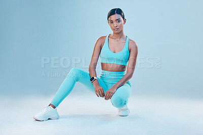 Buy stock photo Fitness, portrait and focus with a sports woman in studio on a blue background for health or wellness. Exercise, mindset and serious with a female athlete training for a healthy body or lifestyle