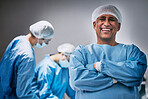 Theatre, portrait and man doctor with arms crossed for hospital teamwork, leadership and medical surgery. Happy surgeon or healthcare person in operating room or theater for emergency and solution
