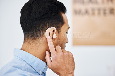 Buy stock photo Hearing aid, deaf and man with ear disability with medical support device as wellness innovation or audiology implant. Patient, auditory and male person with an amplifier for help listening