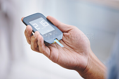 Buy stock photo Hands, diabetes and sugar with a man in his home holding a blood glucose meter for disability awareness. Healthcare, medical and measurement with a diabetic male testing insulin levels in his house