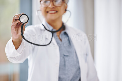 Buy stock photo Woman doctor, stethoscope and cardiologist in hospital for a heart health and wellness consultation. Professional female with healthcare or cardiology tool in hand for medical exam, checkup or care