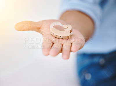 Buy stock photo Hearing aid, hands and person with disability for medical support, wellness and healthcare insurance. Closeup of deaf patient with audiology implant for sound waves, amplifier and help for listening