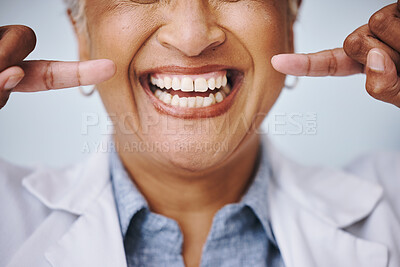Buy stock photo Dental, hand and pointing by elderly woman in studio for mouth, hygiene or denture care on grey background. Teeth whitening, cleaning and senior lady happy for oral, tooth and natural looking veneers
