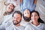 Top view, smile and family on bed, love and bonding with quality time, break and relax together. Portrait, happy parents and mother with father, children and siblings in bedroom, happiness and peace