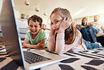 Laptop, floor and children with parents relaxing on sofa for online education, funny video subscription or watch movies. Happy kids on carpet, computer and streaming film together with family at home