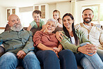 Portrait, love and family on couch, smile and bonding on weekend break, cheerful and relax in living room. Face, grandparents and mother with father, children and siblings on sofa, rest and joyful