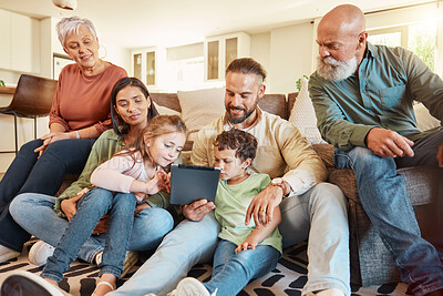 Buy stock photo Love, home and family on a couch, tablet and streaming movies on break, weekend and relax together. Grandparents, mother or father with children, siblings or kids in lounge, social media and chilling