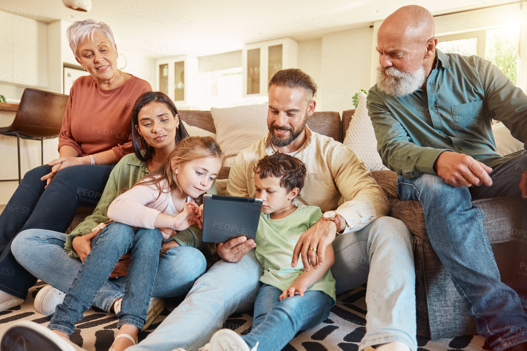 Buy stock photo Love, home and family on a couch, tablet and streaming movies on break, weekend and relax together. Grandparents, mother or father with children, siblings or kids in lounge, social media and chilling