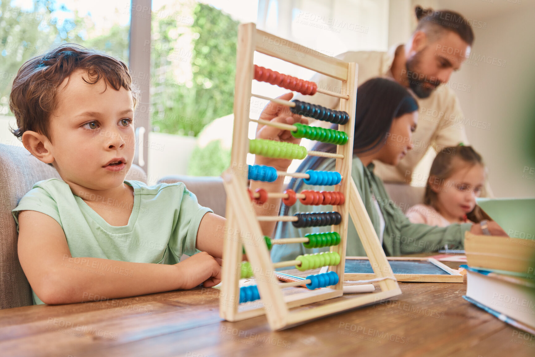 Buy stock photo Education, mathematics and a boy counting on an abacus while learning in the living room of his home. Children, homework and study with a male school kid in his house for growth or child development