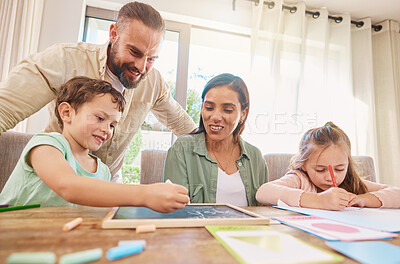 Buy stock photo Family, education and homework with a boy writing on a chalkboard while his parents supervise his learning. Kids, school or study with children, a mother and father at home for growth or development