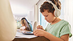 Child, headphones and tablet for education and learning at a home table with internet connection. Boy kid using technology for educational mobile app, streaming video and movies or listening to sound