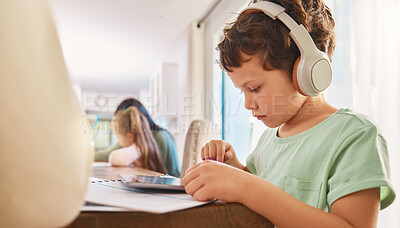 Buy stock photo Child, headphones and tablet for education and learning at a home table with internet connection. Boy kid using technology for educational mobile app, streaming video and movies or listening to sound