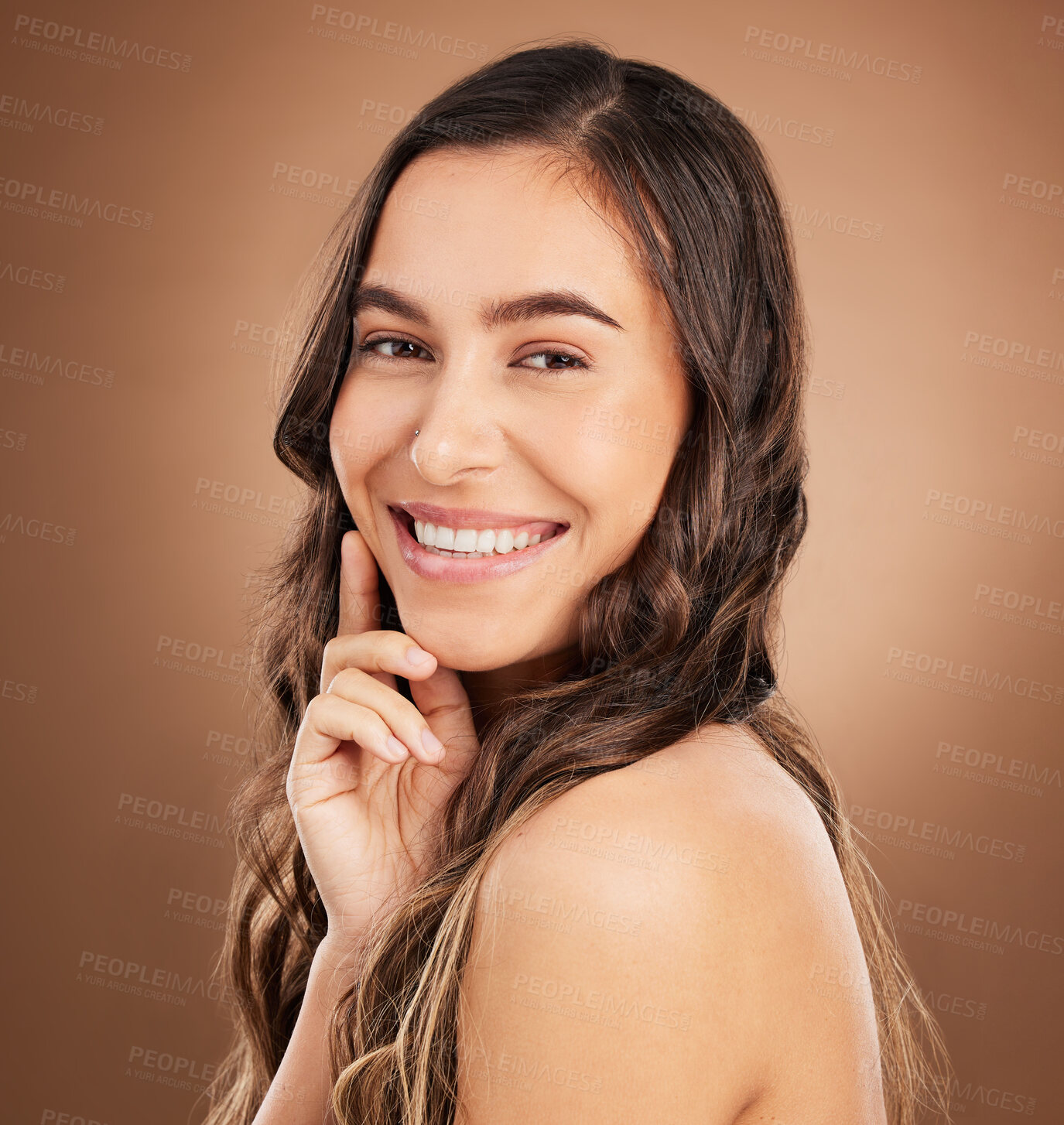 Buy stock photo Portrait, beauty and woman in studio for hair, treatment and cosmetics against a brown background. Haircare, face and girl smile for natural, curly or wavy, texture or keratin, textures and confident