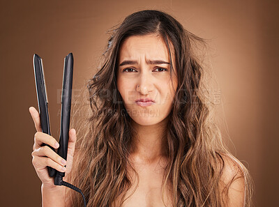 Buy stock photo Hair care, electric straightener and portrait of sad woman on studio background, worried face and dry salon hairstyle. Haircare damage, flat iron and frustrated latino model with spa heat treatment.