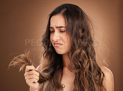 Buy stock photo Beauty, crisis and sad woman in studio with hair loss, dry and damage against brown background. Haircare, fail and girl model frustrated with weak, split ends or alopecia while posing isolated