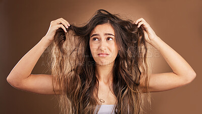 Buy stock photo Problem, hair loss and sad woman in studio for beauty, messy and damage against brown background. Haircare, fail and unhappy girl frustrated with weak, split ends or alopecia while posing isolated