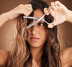 Hair care, damage and woman with scissors, worry and salon cut treatment on brown background. Beauty crisis, haircut and split ends, frustrated latino model with damaged hairstyle on studio backdrop.