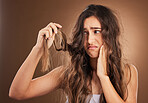 Hair loss, crisis and worried woman in studio for beauty, messy and damage against brown background. Haircare, fail and sad girl frustrated with weak, split ends or alopecia, dandruff and isolated