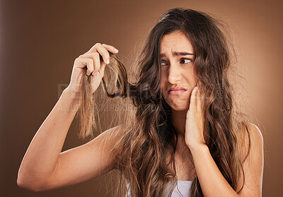 Buy stock photo Hair loss, crisis and worried woman in studio for beauty, messy and damage against brown background. Haircare, fail and sad girl frustrated with weak, split ends or alopecia, dandruff and isolated