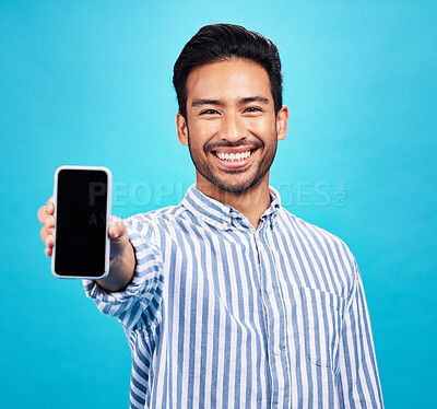 Buy stock photo Phone screen, mockup and portrait of man isolated on blue background for mobile app or advertising space. Happy face of asian person with cellphone mock up for website, contact or ux design in studio