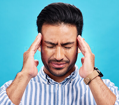 Buy stock photo Man with headache, pain and stress with anxiety and mental health problem or crisis isolated on blue background. Male person hands holding head, massage temple with depression and migraine in studio