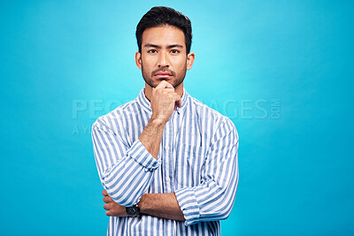 Buy stock photo Portrait of man with focus, blue background and thinking of ideas with serious face isolated on studio backdrop. Confidence, mockup space and professional male model with pride and vision for future.