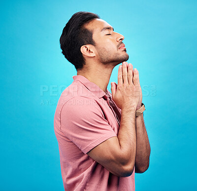 Buy stock photo Man is praying, religion and faith with worship to God, belief and spirituality isolated on blue background. Male person in prayer, Christian and gratitude with mindfulness and peace in studio