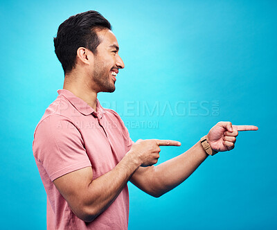 Buy stock photo Mockup, happy and man point on blue background for news, information and deal announcement. Advertising, branding and excited male pointing for copy space, promotion and showing gesture in studio