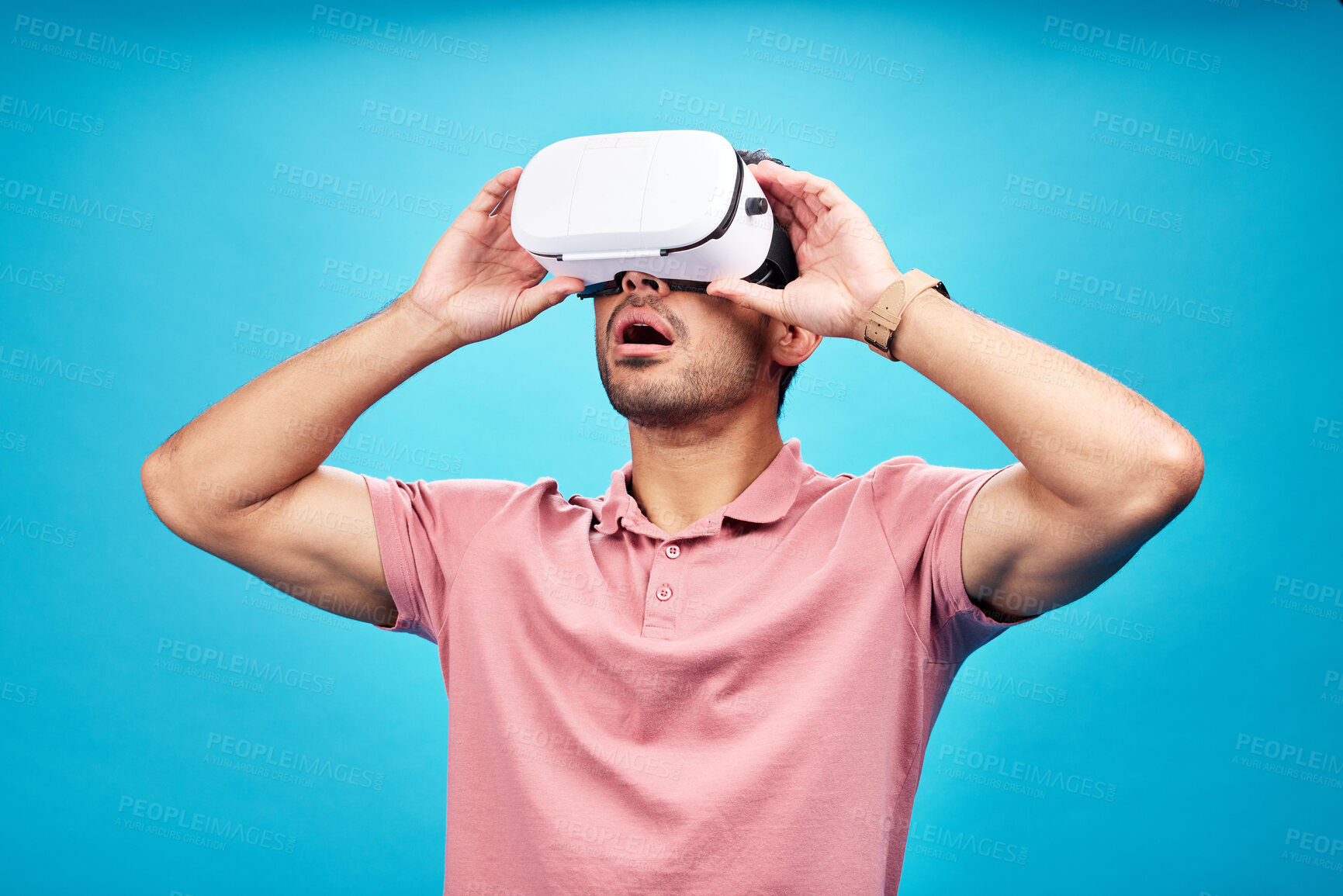 Buy stock photo Man, virtual reality and surprise with UX and metaverse, futuristic technology isolated on blue background. Gamer, VR headset or goggles, male person in digital world with wow expression in studio