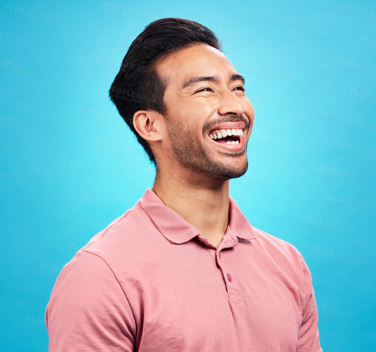 Buy stock photo Funny comedy, laughter and man in studio isolated on a blue background. Comic, humor and Asian person laughing at joke, happiness and carefree for hilarious smile, excited and cheerful with emoji.