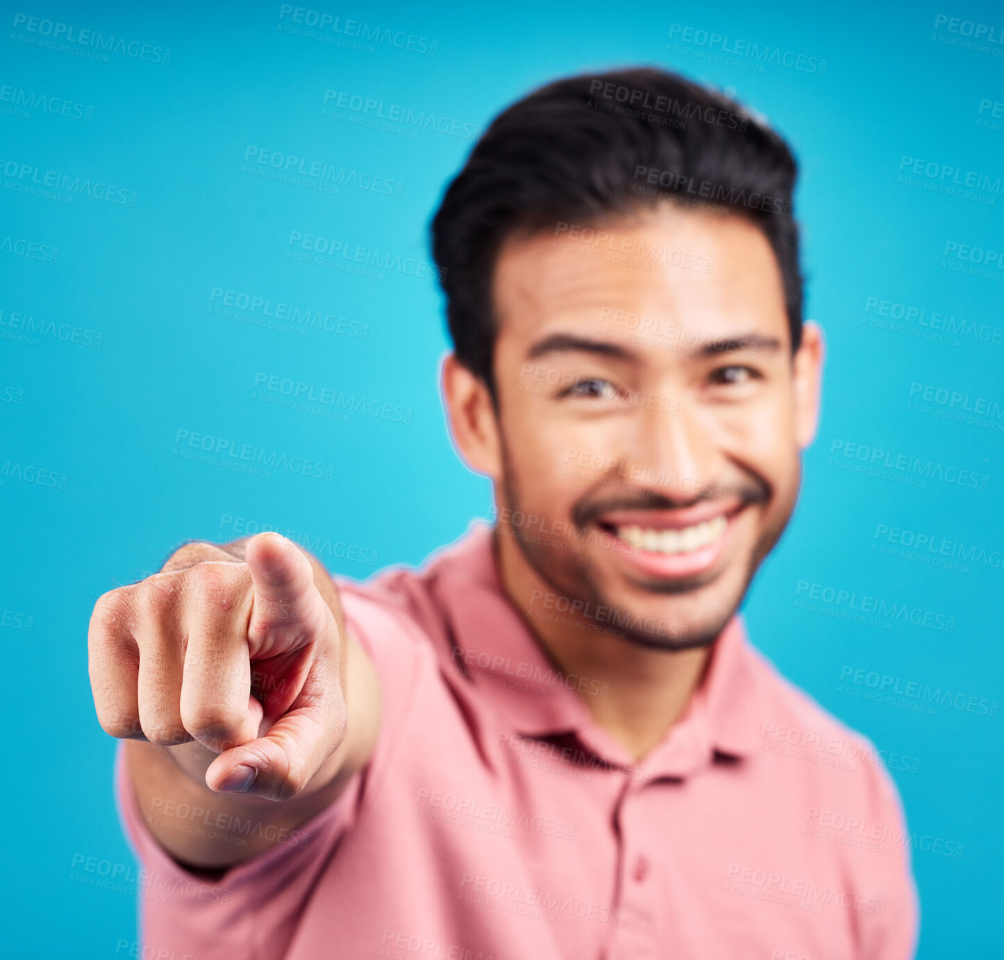 Buy stock photo Pointing, focus and portrait of man in studio for motivation, choice and decision. Happy, smile and yes with male and hand gesture isolated on blue background for hey you, offer and emoji mockup