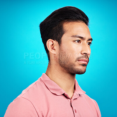 Buy stock photo Thinking, serious and profile of Asian man in studio isolated on a blue background. Idea, side face and male person contemplating, lost in thoughts or problem solving while looking for a solution.