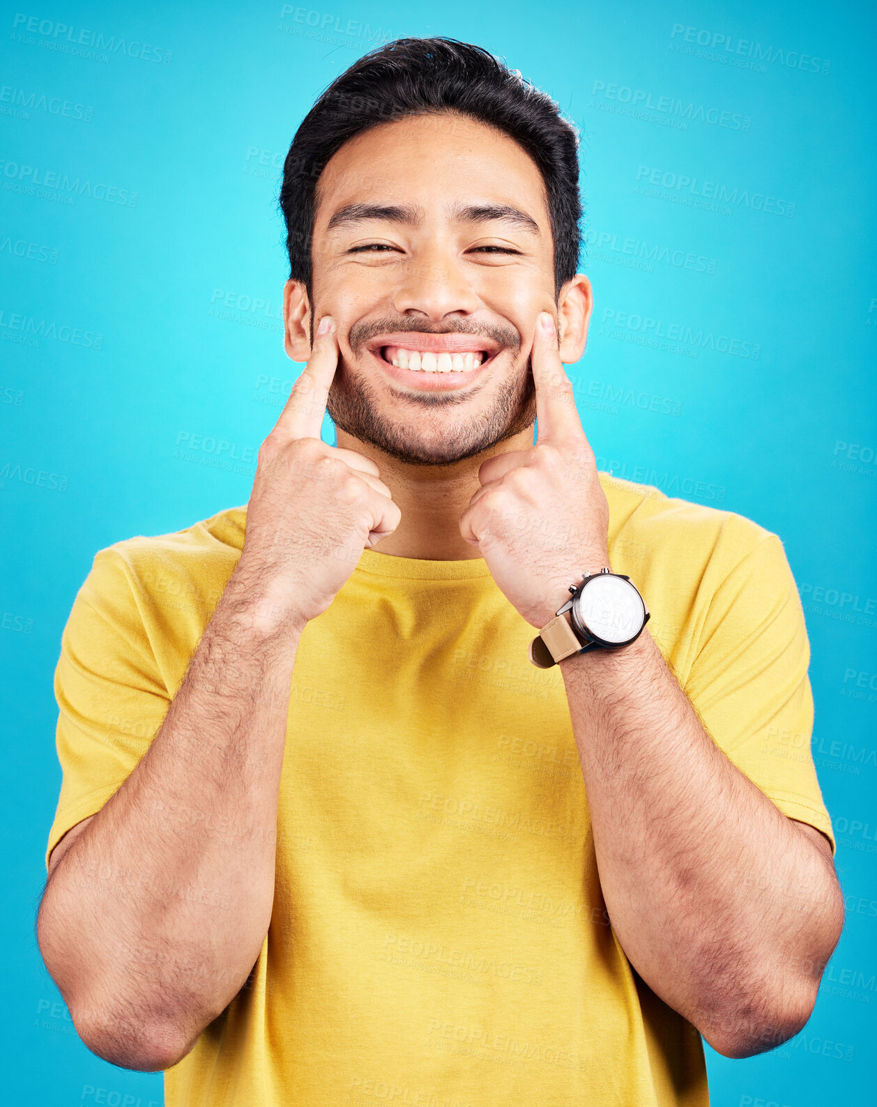 Buy stock photo Happy, smile expression and portrait of a man expressing happiness, joy and cheerful face. Young, confident and a person smiling for positivity and confidence isolated on a blue background in studio