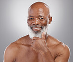 Happy senior black man, portrait smile and skincare for personal hygiene or profile against a gray studio background. African American elderly male smiling with beard for healthy or perfect skin