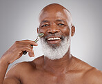 Face roller, portrait and senior black man with skincare, stone and dermatology product for skin glow. Elderly, cheek and facial roll of a male model doing self care for cleaning with jade for beauty