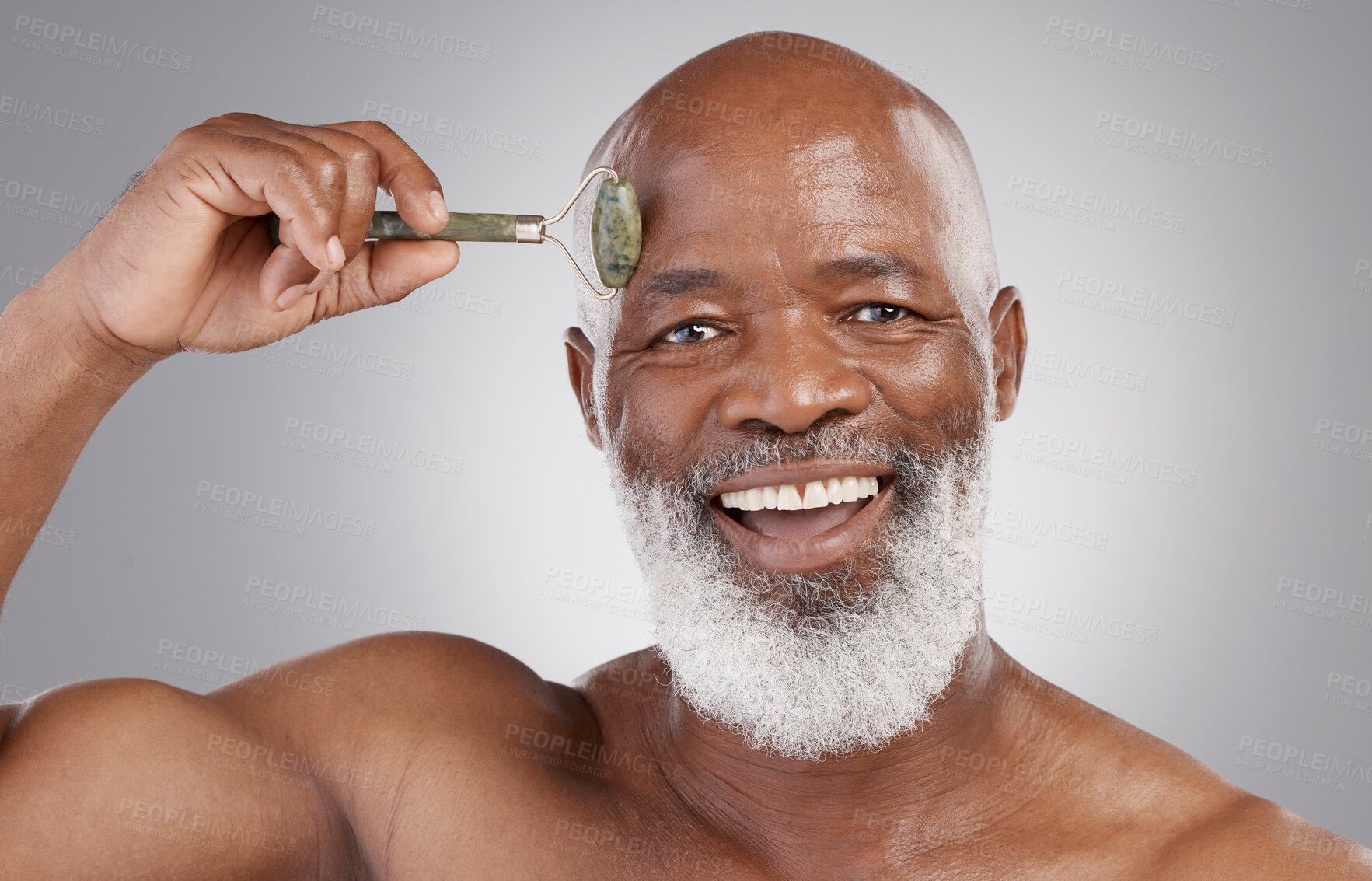 Buy stock photo Face roller, portrait and senior black man with skincare smile, stone and dermatology product for skin glow. Elderly, grooming and facial jade roll for male model in self care for anti aging beauty