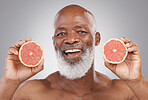 Senior black man, grapefruit and smile for vitamin c, healthy skincare or natural nutrition against gray studio background. Portrait of happy African male with fruit for skin, healthcare or wellness