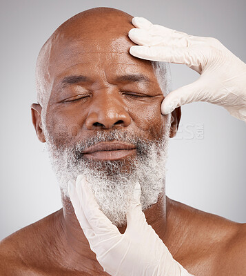 Buy stock photo Skincare, hands or gloves for black man in cosmetic treatment, professional anti ageing or white background. Dermatology, face and mature male model at salon or clinic for medical skin care in studio