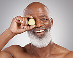 Senior black man, portrait smile and cucumber for natural skincare, nutrition or health against a gray studio background. Happy African American male with vegetable for healthy skin, diet or wellness