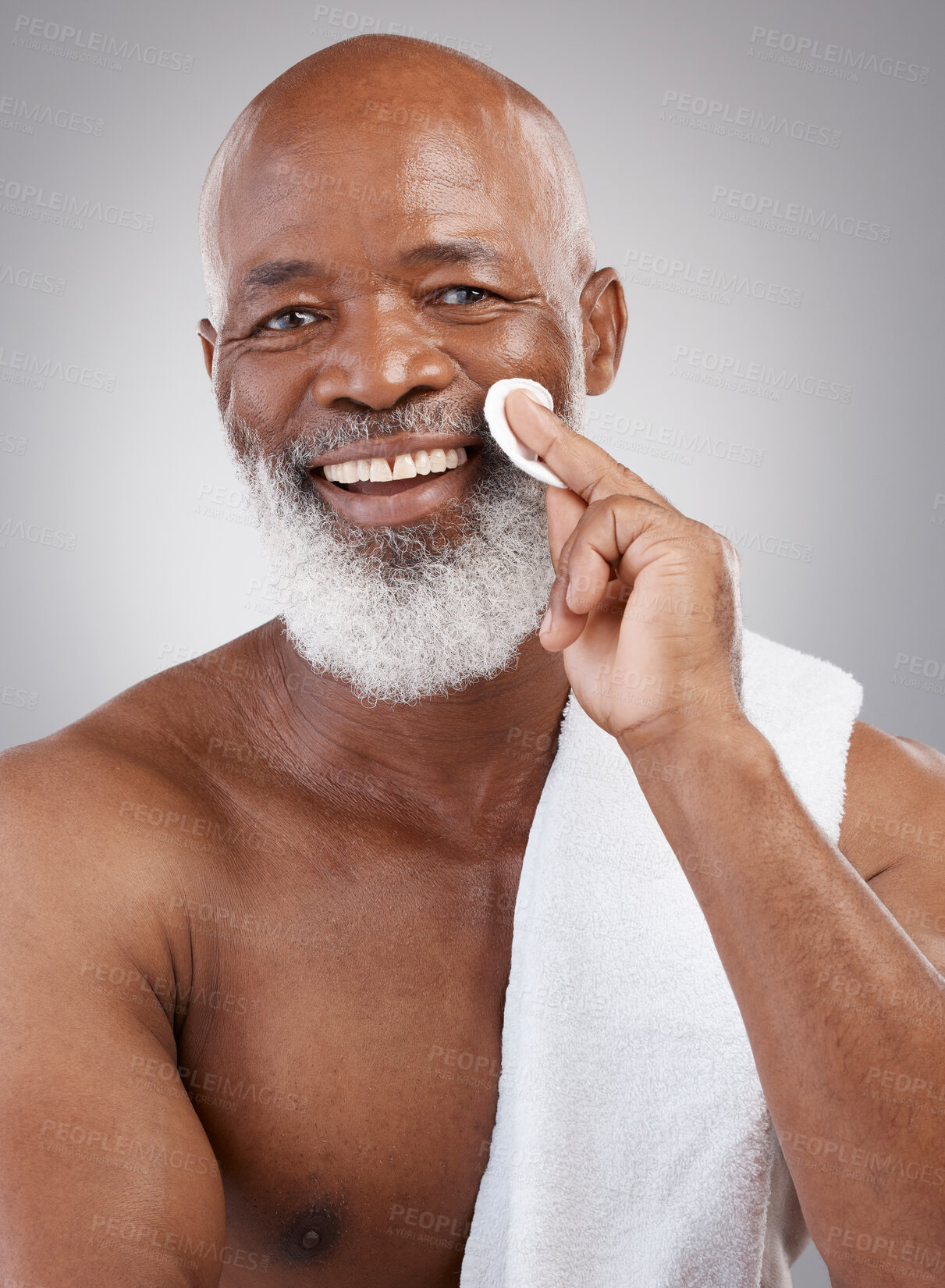 Buy stock photo Skincare, cotton pad and portrait of black man with happiness, cleaning and anti ageing treatment.  Dermatology, cosmetic process and happy, mature model with smile and cleansing routine in studio.