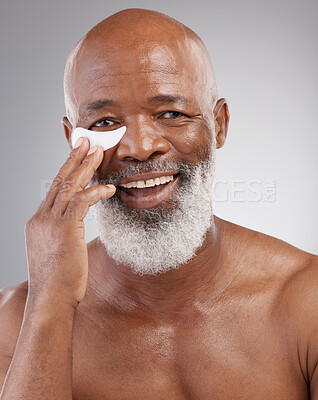 Buy stock photo Skincare, eye pad or portrait of man with smile, happiness and anti ageing face treatment. Dermatology, cosmetic grooming or happy, mature and African model or collagen eyes mask on white background