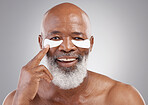 Skincare, collagen eye mask and portrait of black man with smile, happiness and treatment on white background Dermatology, cosmetic process and happy, mature model with pad on eyes in studio backdrop