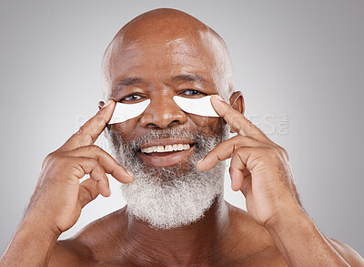 Buy stock photo Dermatology, eye pads on face and portrait of black man with smile, happiness and anti ageing collagen spa treatment. Skincare, cosmetic process and happy, mature model in morning skin care routine.