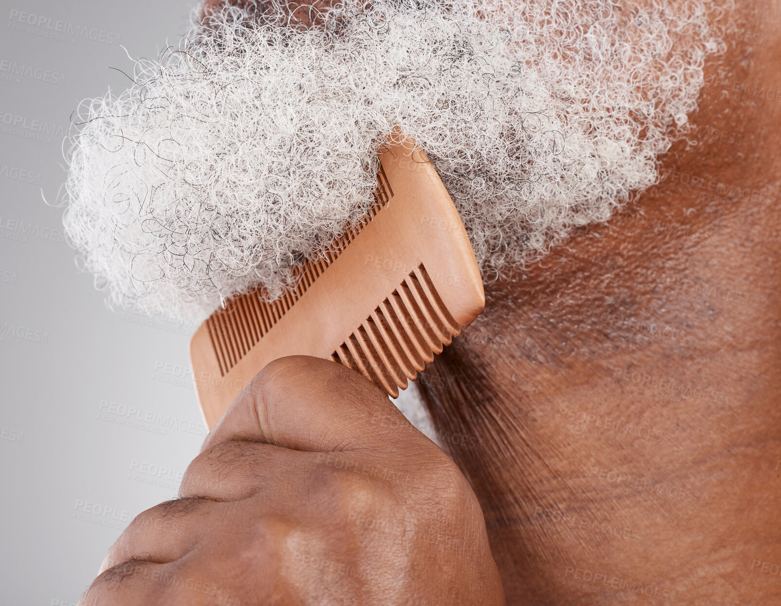 Buy stock photo Man, hands and beard with comb in grooming, beauty or skincare hygiene against a studio background. Closeup of senior male neck and chin combing or brushing facial hair for clean wellness or haircare