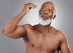 Skincare, serum and face of senior black man for wellness, cosmetics and facial care on studio background. Dermatology, beauty and male person with essential oil for anti aging, wrinkle and hydration