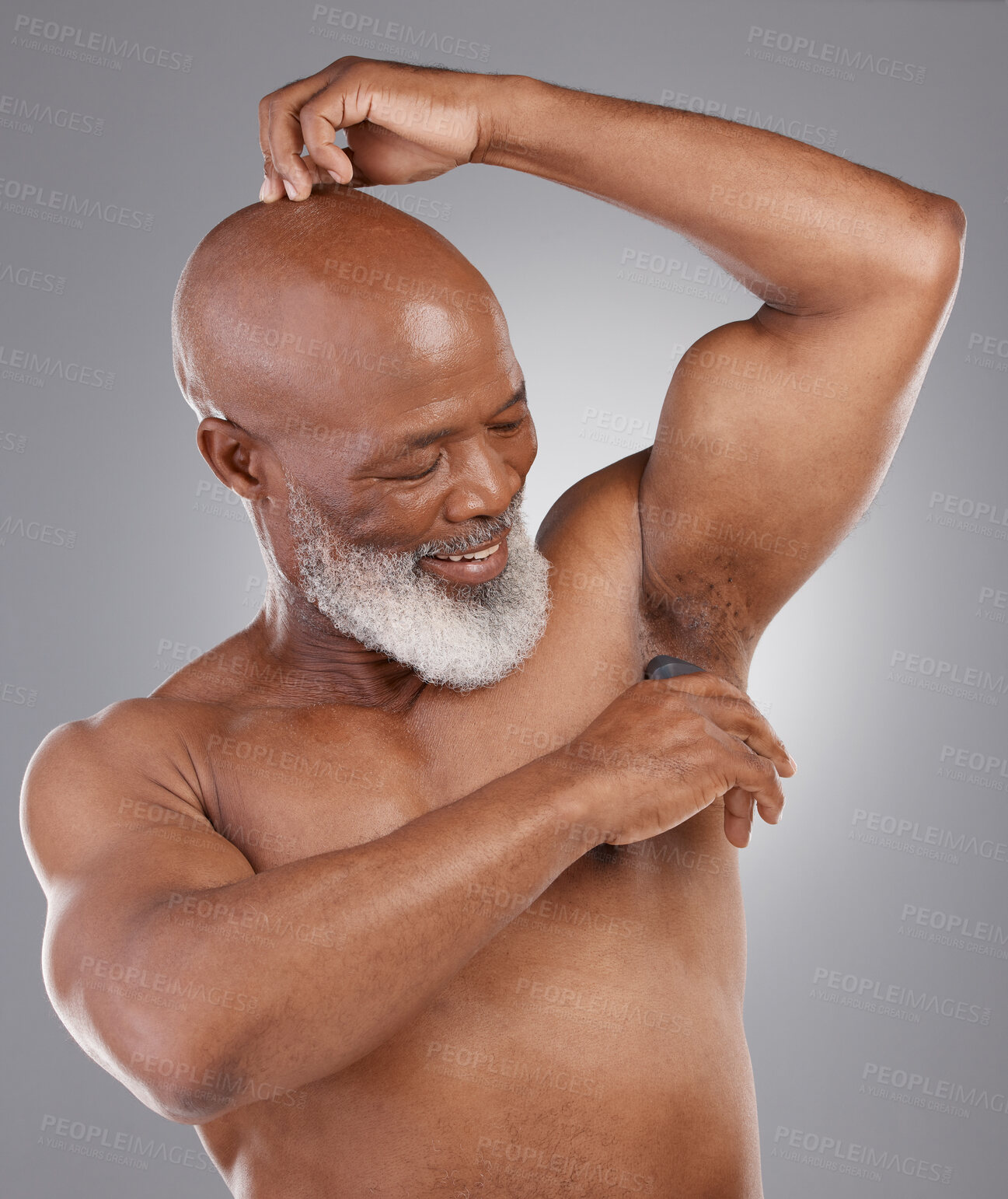 Buy stock photo Senior black man, deodorant and armpit for skincare, grooming or person hygiene against a gray studio background. Happy elderly African American male applying cosmetics for fresh or clean smell