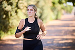 Music, runner or woman running in park training, cardio exercise or endurance workout for marathon. Sports, fitness or healthy girl athlete exercising on jog streaming audio or radio song in nature