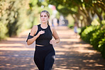 Music, runner or girl running in park training, cardio exercise or endurance workout for marathon. Sports, fitness or healthy athlete woman exercising on jog streaming audio or radio song in nature