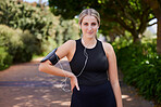 Headphones, runner or portrait of woman in park training, exercise or workout for a healthy body. Wellness, fitness break or sports girl athlete exercising or streaming audio or radio song in nature