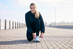 Portrait, shoelace and happy woman runner at beach with performance, preparation or warm up. Fitness, shoes and face of girl with positive, mindset or smile before run, training and workout exercise